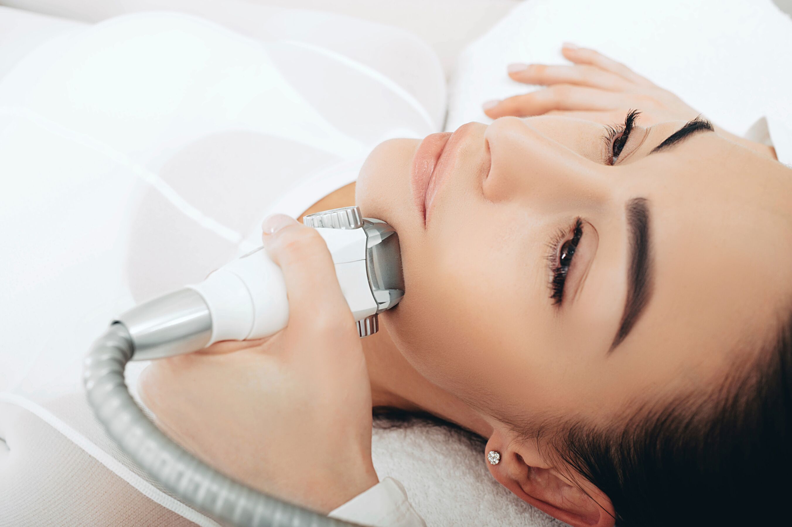 A person lying down with a medical device on their face.
