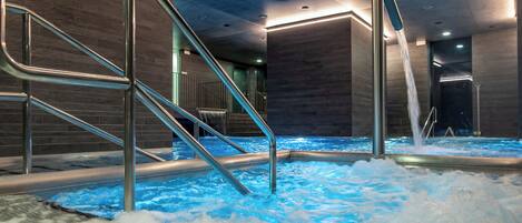 A hot tub area with metal railings and a water fountain.