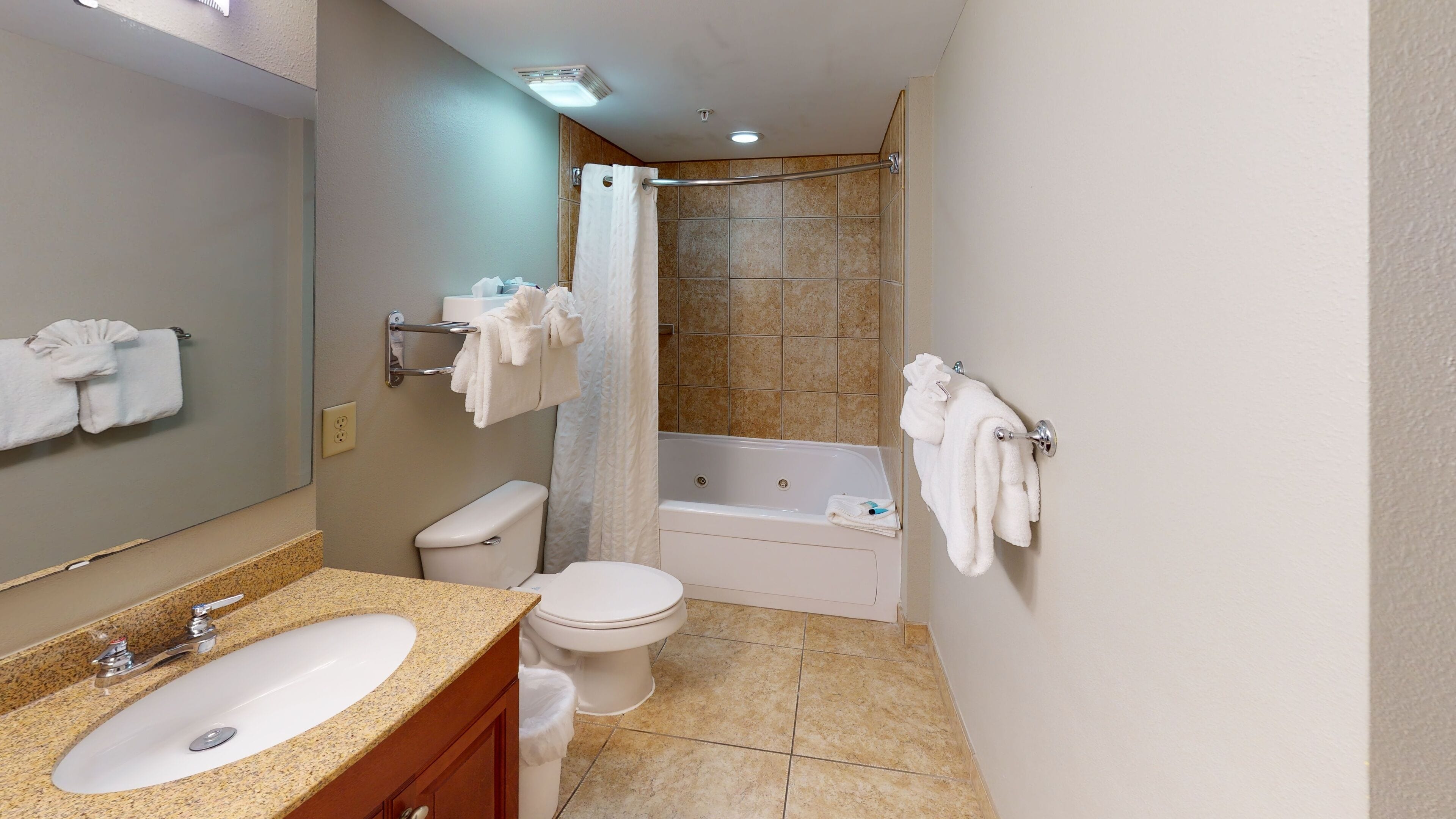 A modern bathroom with a sink, toilet, bathtub, and shower.