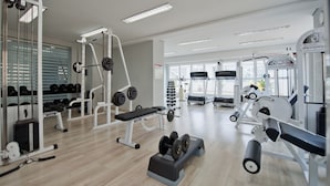 A modern gym with various exercise equipment, including weight machines, treadmills, and dumbbells. - HB Hotels Sequóia Alphaville (Barueri)
