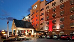 A hotel with a prominent sign reading "Four Points by Sheraton" and a parking lot with several cars. - Four Points by Sheraton Louisville Airport (Louisville)