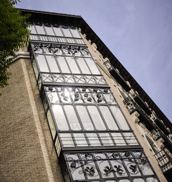 A building with large windows and ornate metal railings. - Catalonia El Pilar (Zaragoza)