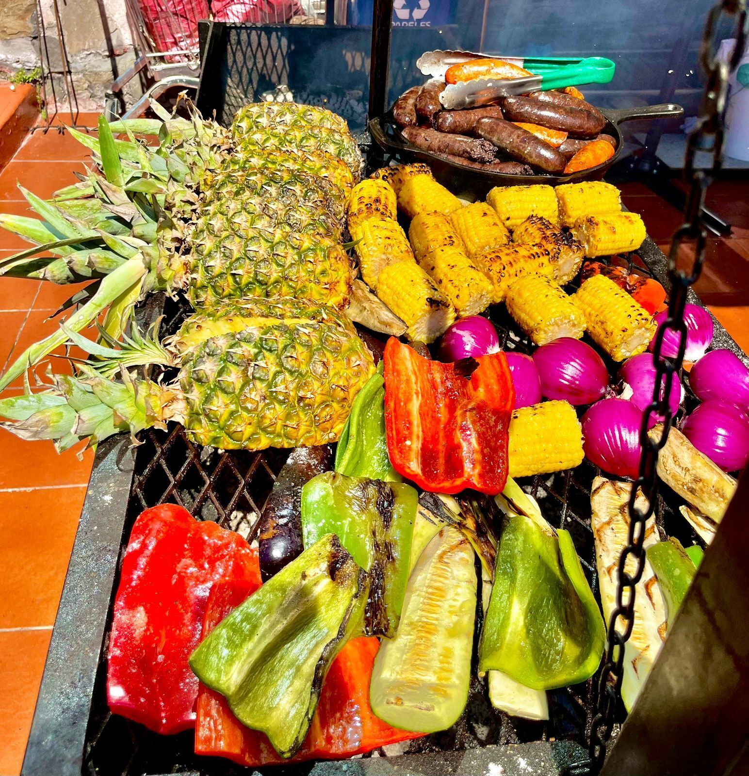 A variety of grilled vegetables and fruits on a grill.