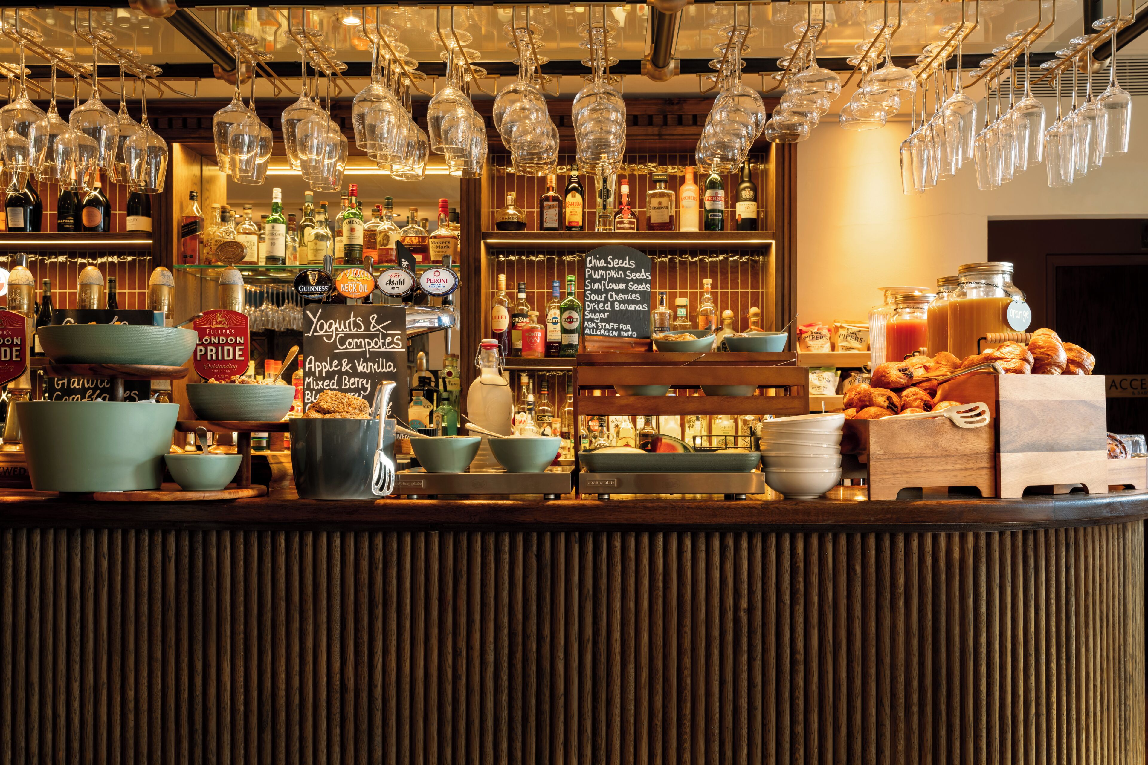 A bar area with a variety of bottles, glasses, and bowls.