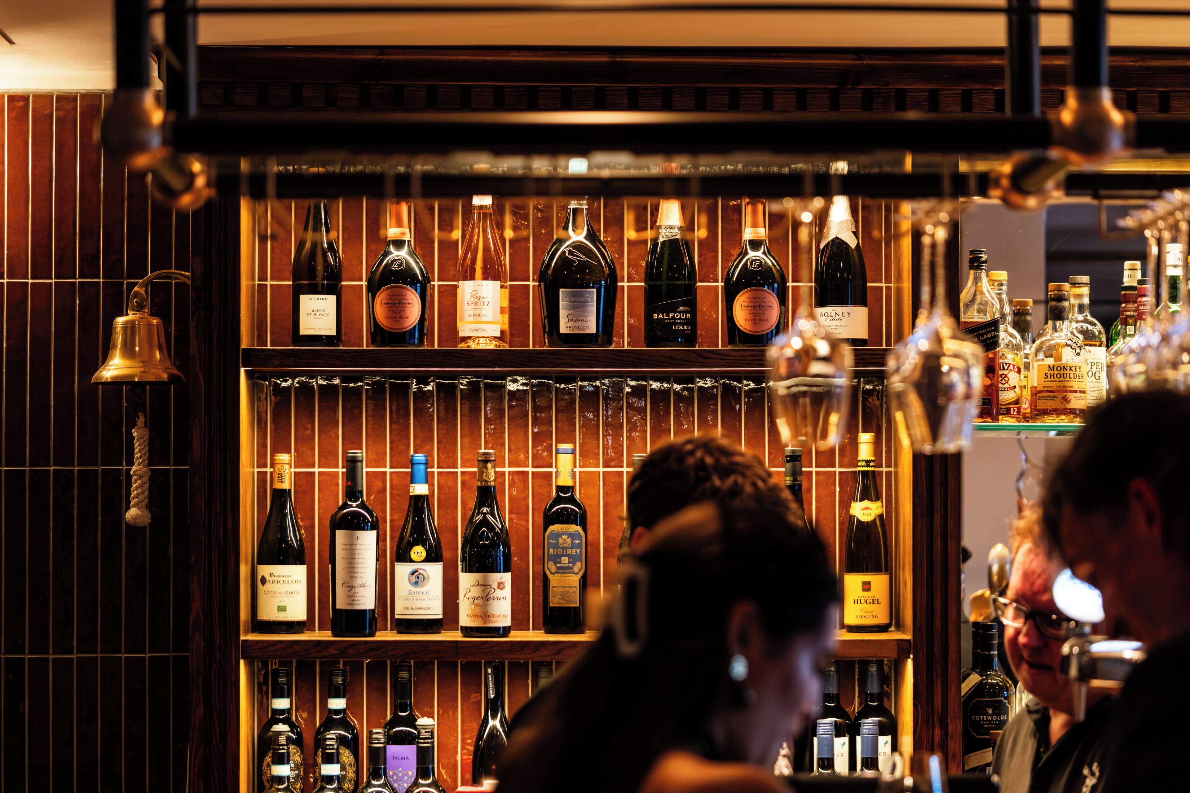 A bar with shelves of various liquor bottles.