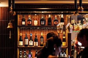 A bar with shelves of various liquor bottles.