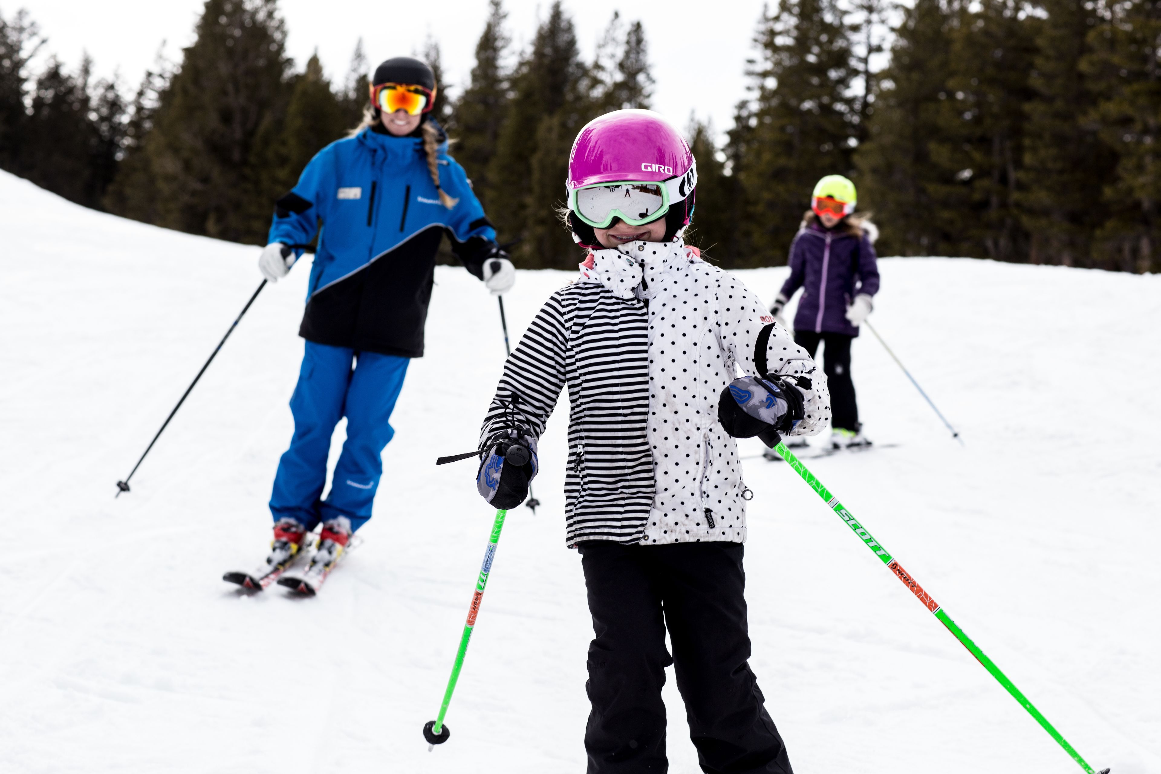 A snowy ski slope with skiers.