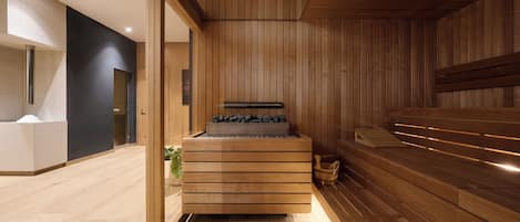 A modern sauna room with wooden walls and a bench.