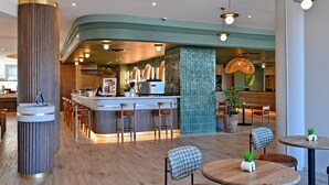 A modern bar area with a curved counter, bar stools, and pendant lighting. - City Lodge Hotel Umhlanga Ridge (Umhlanga)