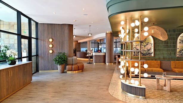 A modern lobby with wooden flooring, a reception desk, seating areas, and a unique light installation. - City Lodge Hotel Umhlanga Ridge (Umhlanga)