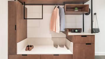 A modern, multi-functional piece of furniture with a built-in shoe rack, a hanging shelf, and a small workspace area.