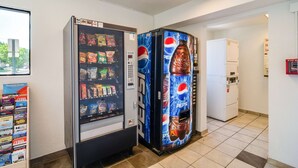 A vending machine area with a Pepsi-branded machine and a CityPASS machine. - Motel 6 Schiller Park, IL - Chicago O'Hare (Schiller Park)