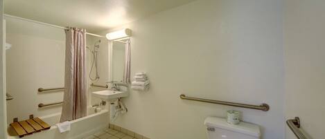 A bathroom with a bathtub, a sink, a toilet, and a shower.
