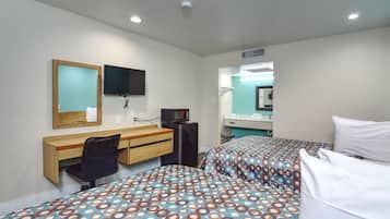 A hotel room with two beds, a desk with a chair, a TV, and a mirror.