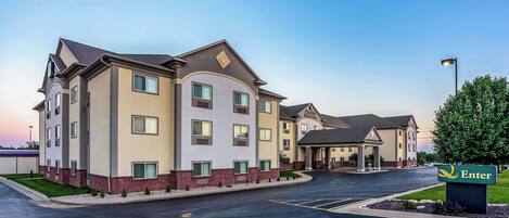 A hotel with a modern design, featuring a central courtyard and multiple entry points.