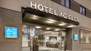 The exterior of Hotel AC Elda, part of the AC Hotels Marriott chain, featuring a modern facade with large glass windows and a prominent entrance. - AC Hotel Elda by Marriott (Elda)