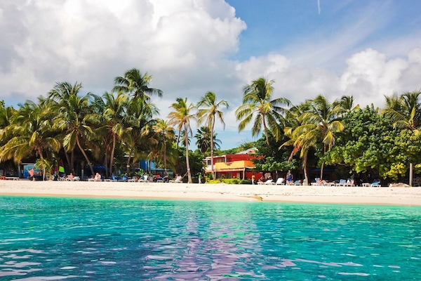 On the beach, white sand, sun loungers, beach towels