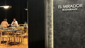 The interior of El Mirador Restaurante with hexagonal tile flooring, wooden tables, and chairs. - Hotel Mendoza (Mendoza)