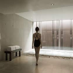 Enjoy a serene bathroom retreat with a view of a water feature and a clean, neutral design.