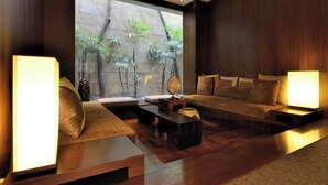 A modern living room with a large window, wooden furniture, and a globe on a side table. - Les Suites Taipei Ching Cheng (Taipei)
