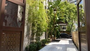 A modern building with a paved walkway, large windows, and greenery. - Les Suites Taipei Ching Cheng (Taipei)