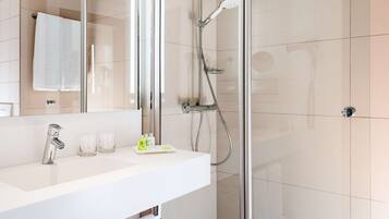 Bathtub, eco-friendly toiletries, hair dryer, towels