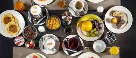 A breakfast buffet with various food items and beverages.