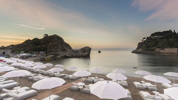 On the beach, sun-loungers, beach umbrellas, beach towels