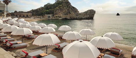 On the beach, sun loungers, beach umbrellas, beach towels