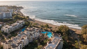 A resort with multiple buildings, a beach, and a swimming pool. - Marriott's Playa Andaluza (Estepona)