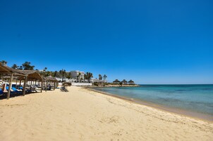 Private beach, white sand, sun loungers, beach umbrellas