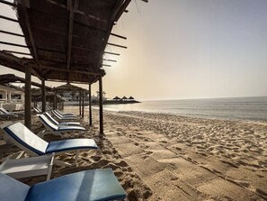 Private beach, white sand, sun-loungers, beach umbrellas