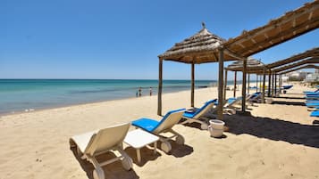 Private beach, white sand, sun loungers, beach umbrellas