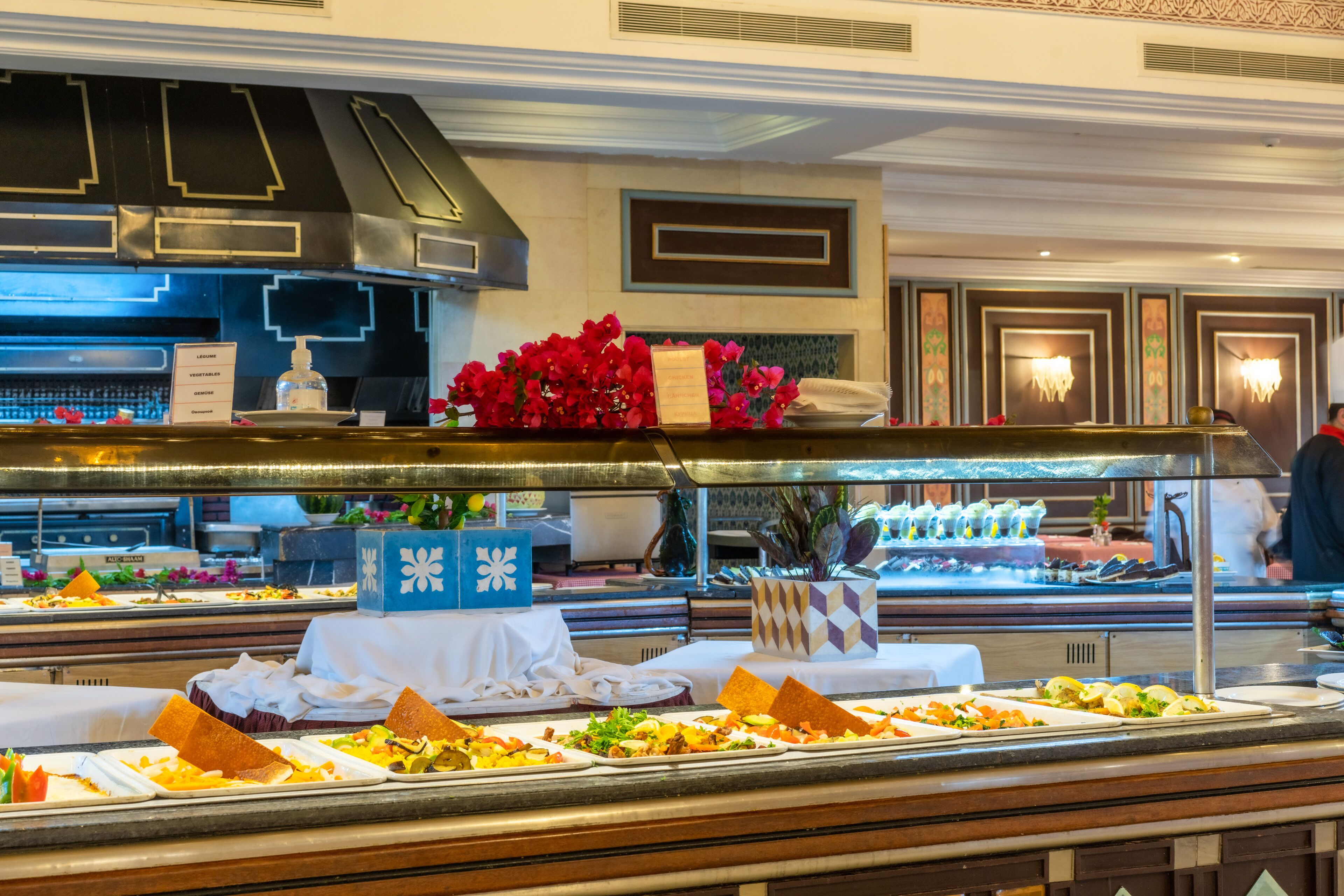 A buffet setup with various food items and a decorative centerpiece.