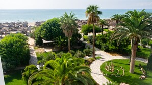 A resort with a beach view, palm trees, and a well-maintained garden. - The Orangers Beach Resort and Bungalows - All Inclusive (Hammamet)