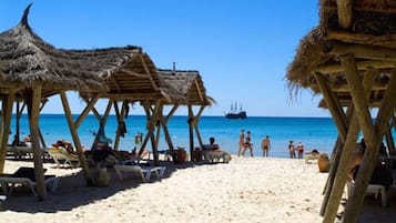 Private beach, white sand, sun loungers, beach umbrellas