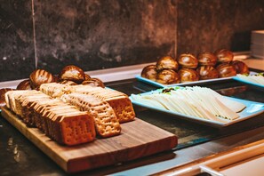 A variety of baked goods on display, including bread, pastries, and cookies. - The Orangers Beach Resort and Bungalows - All Inclusive (Hammamet)