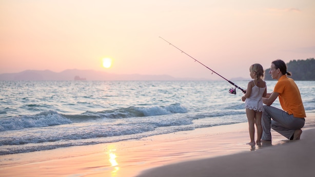 A couple fishing on a beach during sunset. - Mackay Seabreeze Apartments (Slade Point)
