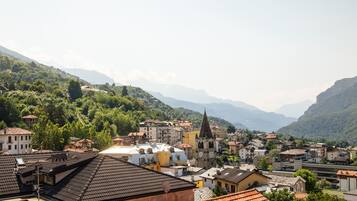 A town nestled in a valley with traditional buildings, a prominent church, and lush greenery.