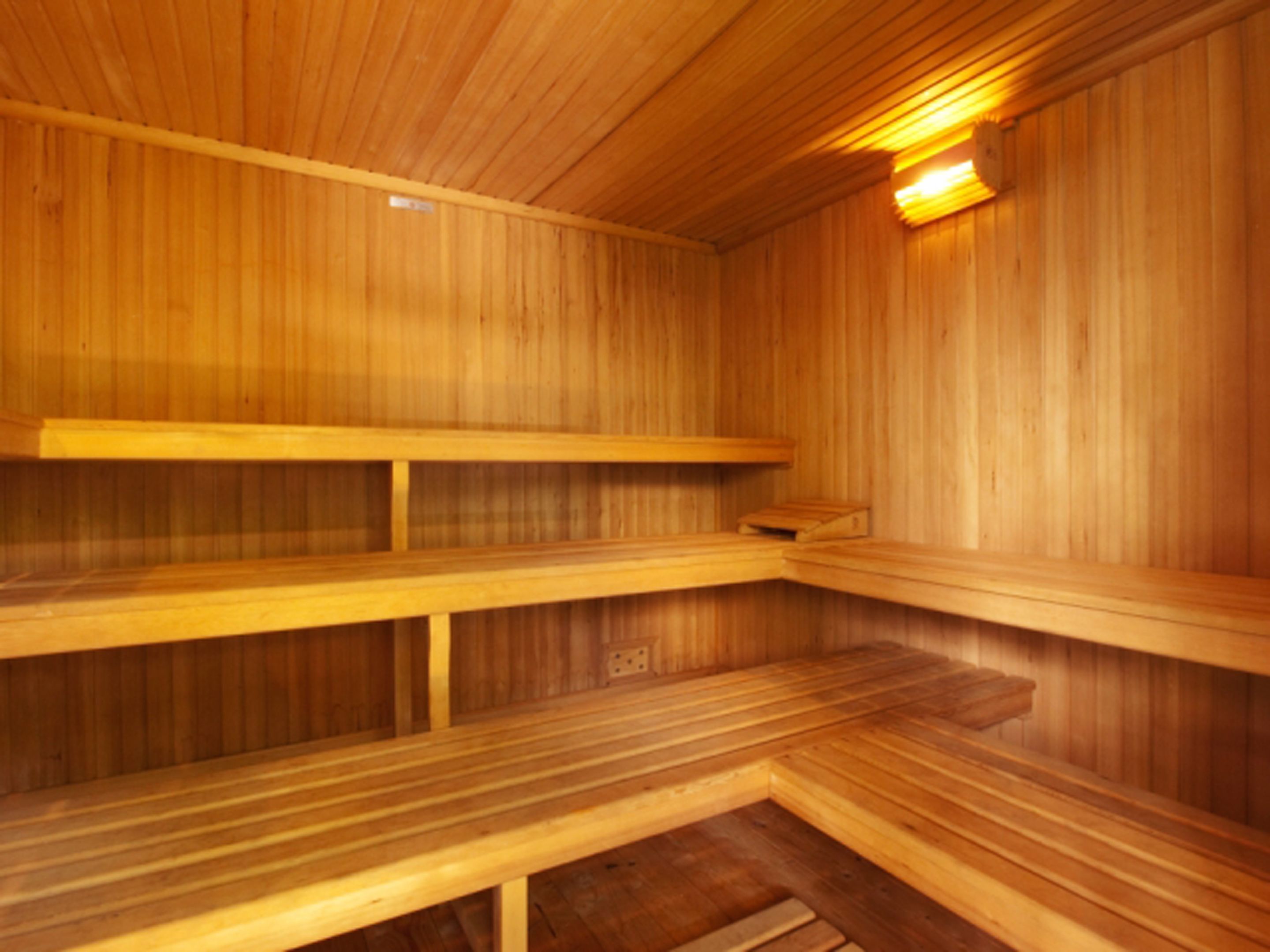 A wooden sauna with benches and a bench seat.