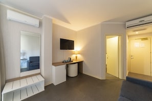 Classic Quadruple Room | Minibar, in-room safe, desk, blackout drapes