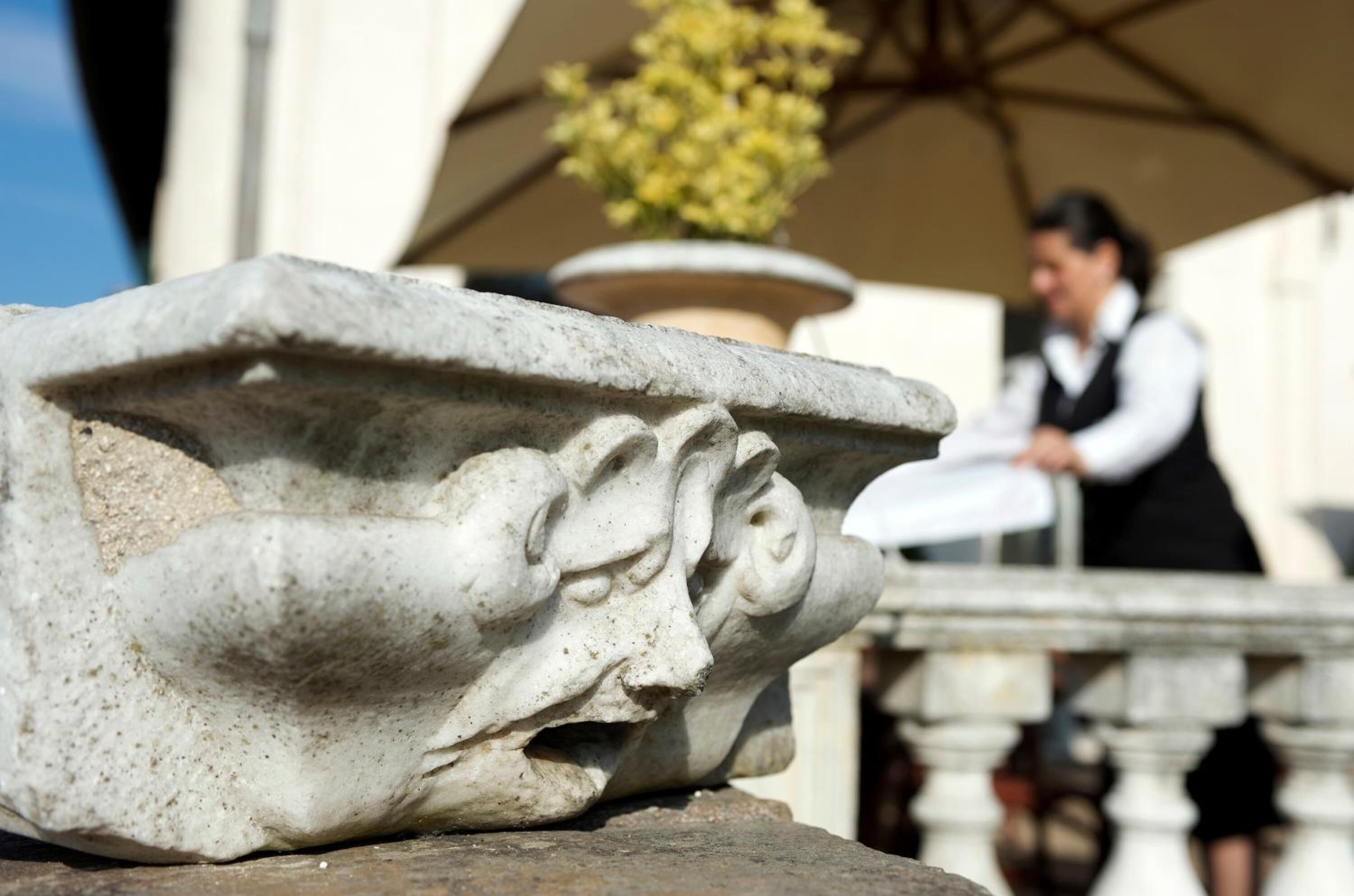 A stone sculpture with intricate carvings, possibly part of a historical building's architecture.