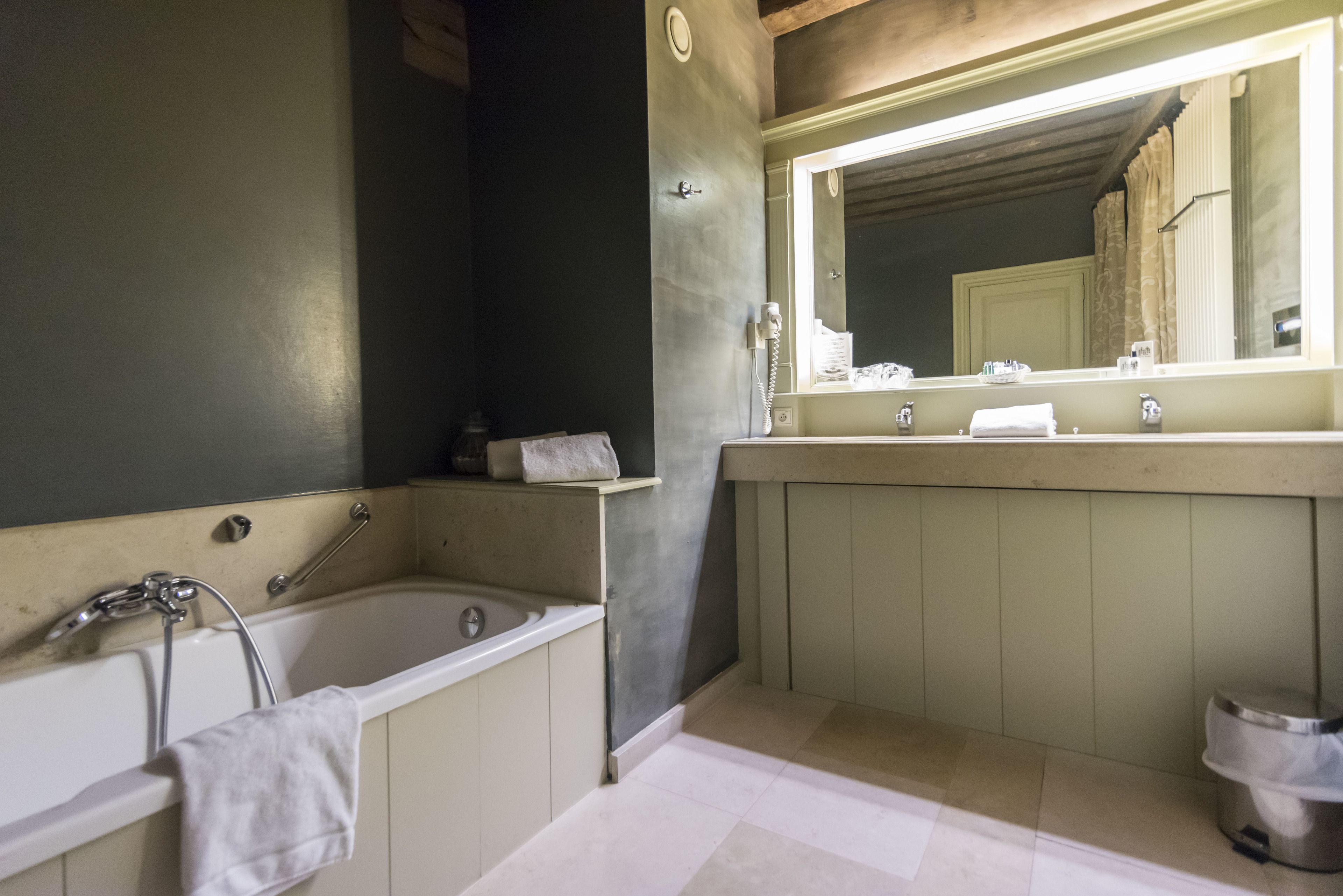 bathtub, designer toiletries, hair dryer, towels