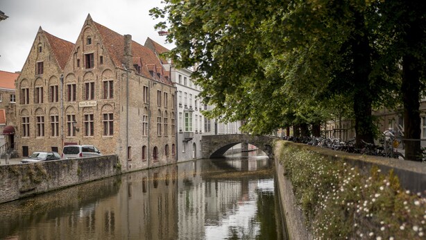 A historic building with a sign that reads "Hotel To Brugge" across the front.
