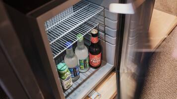 A refrigerator with shelves containing various beverages and condiments.