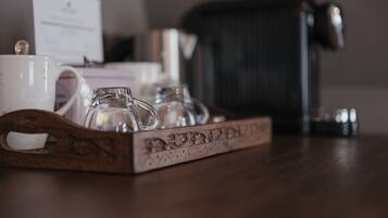 A tray with a white mug, a glass, and a small pitcher on a wooden table.