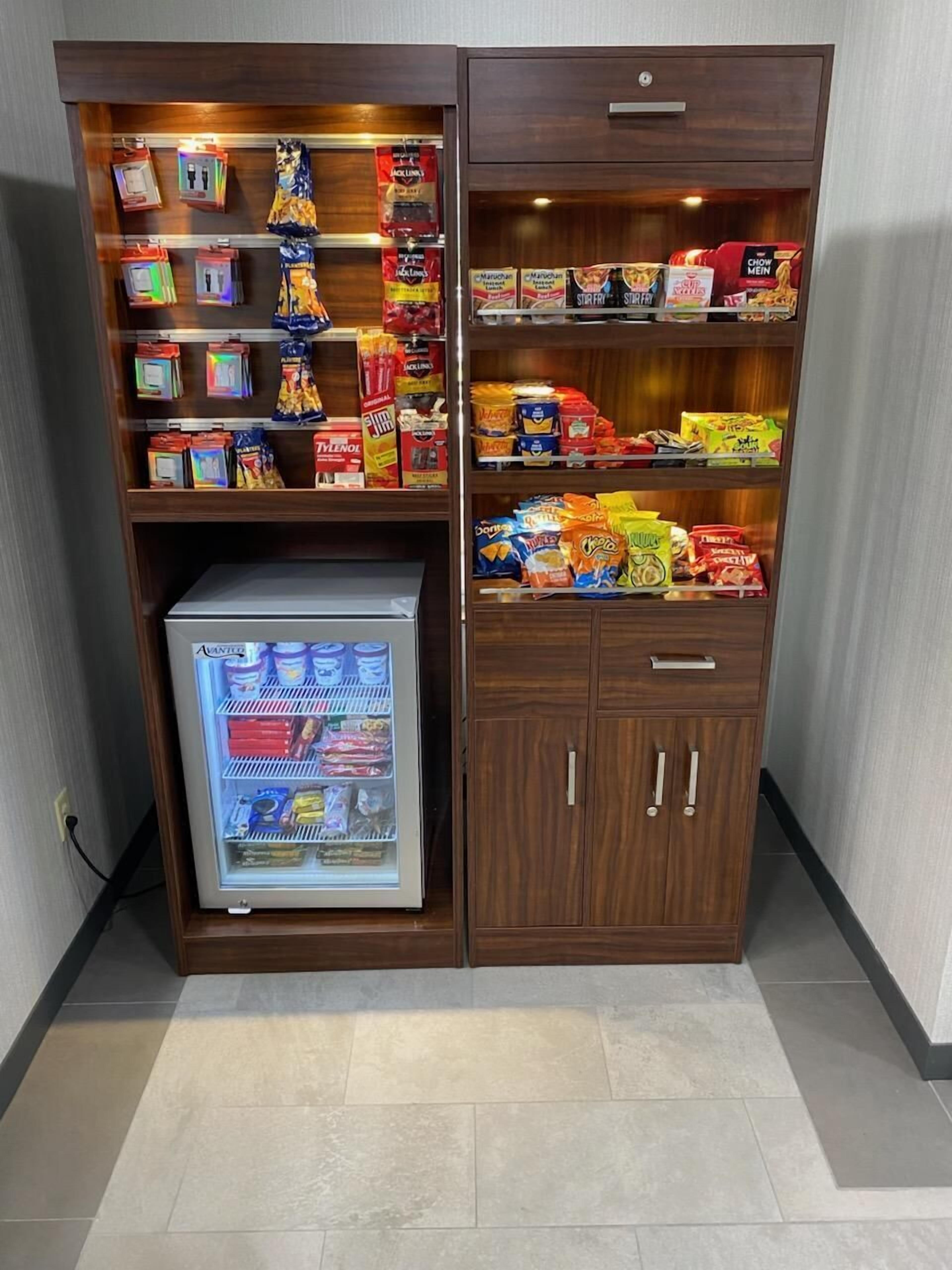 A minibar with snacks, a beverage cooler, and a small refrigerator.