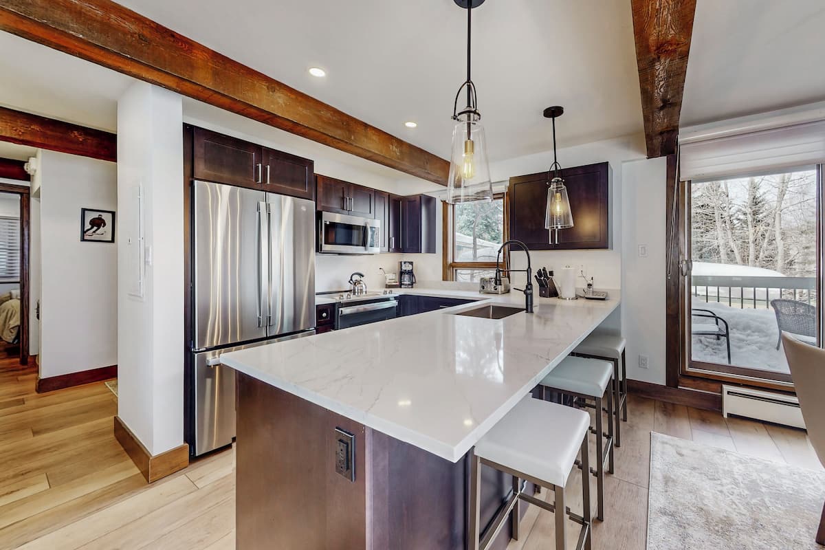 Enjoy cooking in this kitchen with a large island, stainless steel appliances, and a spacious countertop.