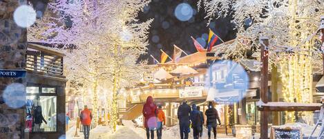 A snowy outdoor area with a sign for 'Live Music Tonight' and a 'Welcome' sign.