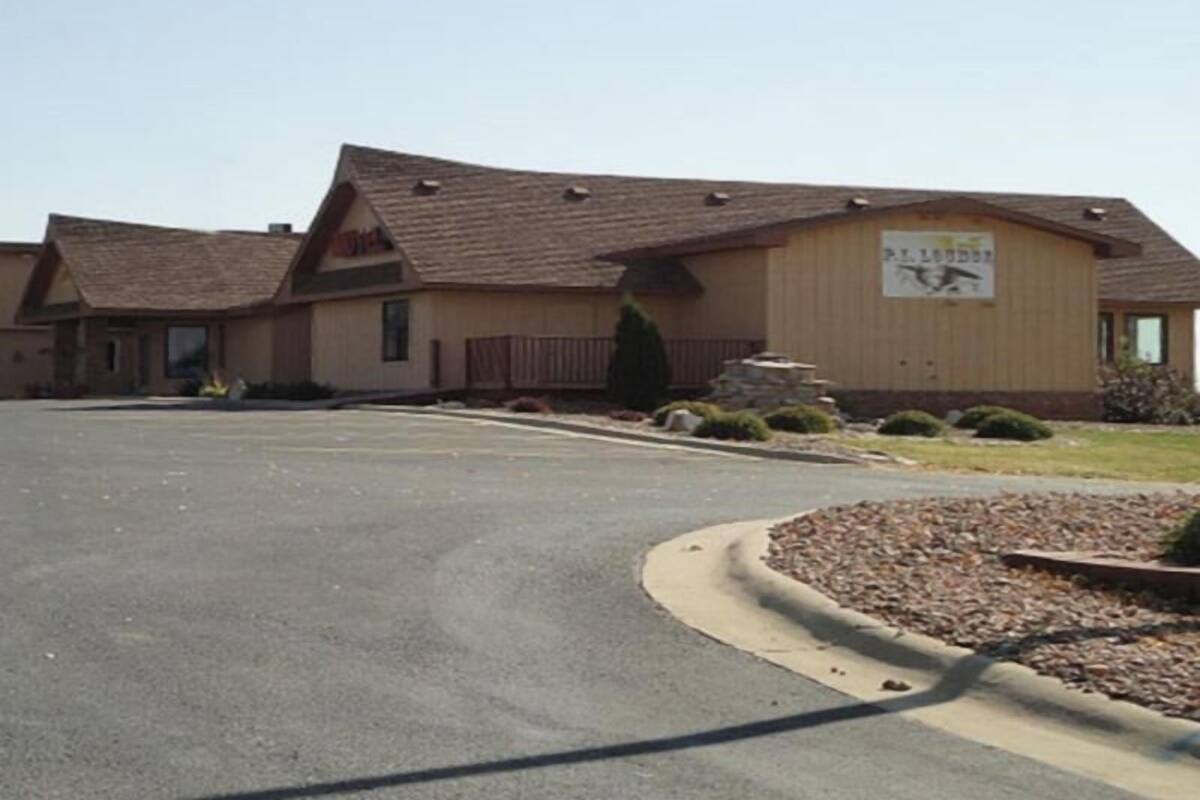 A building with a sign reading 'St. Louder' and a parking lot in front.